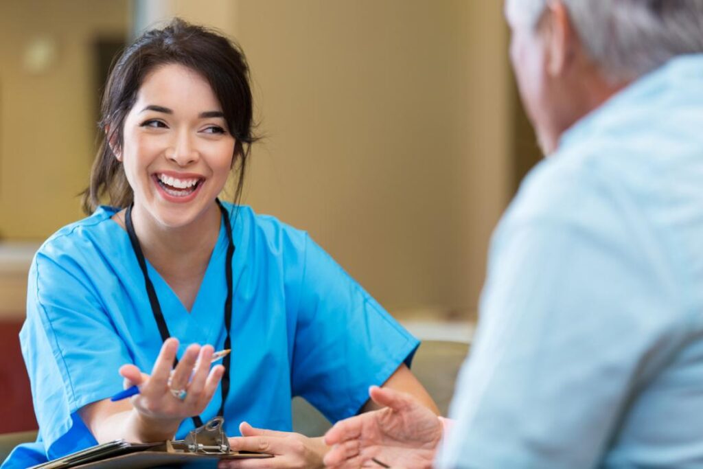 Smiling healthcare provider discussing CMS 2019 compliance updates with patient.