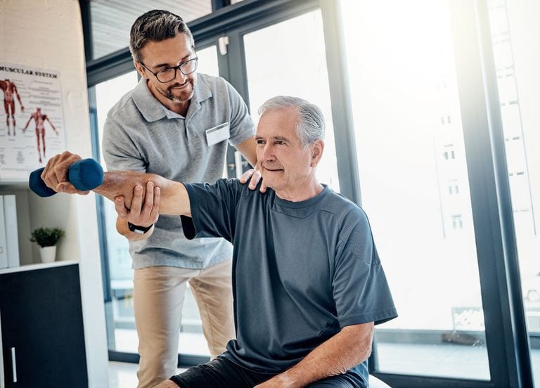 Rehabilitation specialist guiding older patient through exercise, symbolizing efficient patient care.